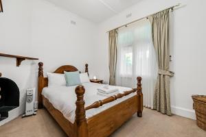 a bedroom with a bed and a window at Swainson on Church in Norwood