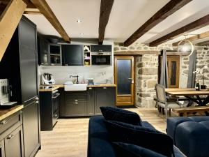 a kitchen and living room with a table and chairs at Le Quatorze 