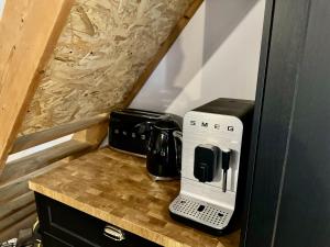 a small kitchen with a coffee maker on a counter at Le Quatorze 