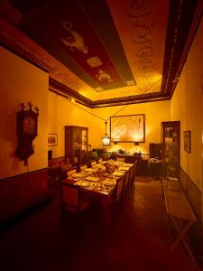 a dining room with a long table with chairs at Casa Santangelo Suites in Salerno