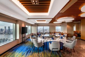 a conference room with a table and chairs and a large window at Novotel Atlantis Shanghai - Enjoy our great-valued breakfast in our rooftop revolving restaurant with a stunning river view & utilize our FREE self-serviced laundry in Shanghai