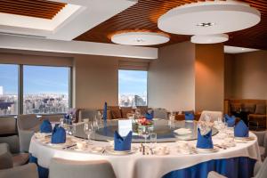 a conference room with a table with blue napkins at Novotel Atlantis Shanghai - Enjoy our great-valued breakfast in our rooftop revolving restaurant with a stunning river view & utilize our FREE self-serviced laundry in Shanghai