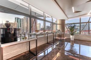 a restaurant with a view of a city skyline at Novotel Atlantis Shanghai - Enjoy our great-valued breakfast in our rooftop revolving restaurant with a stunning river view & utilize our FREE self-serviced laundry in Shanghai