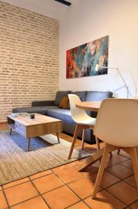 a living room with a couch and a table at Casa 1928 - 1 DER - Plaza de España in Seville