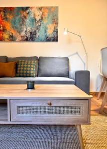 a living room with a couch and a coffee table at Casa 1928 - 1 DER - Plaza de España in Seville