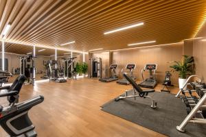 a gym with several treadmills and cardio machines at Novotel Atlantis Shanghai in Shanghai