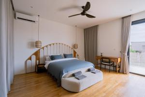 a bedroom with a bed and a ceiling fan at Unity Villa 1 Canggu in Canggu +83 photos