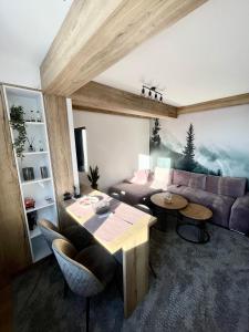 a living room with a couch and a table at Pinewood apartment Jahorina in Jahorina