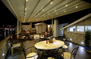 a restaurant with a table and chairs and lights at Lodos Butik Hotel in Alaçatı +37 photos