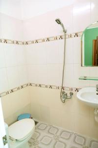 a bathroom with a toilet and a sink at Lucky Home in Nha Trang