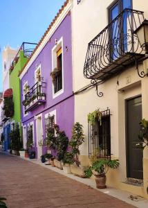 a row of buildings with potted plants on a street at Home SEA&DREAMS OldTown V in Calpe