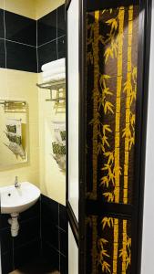 a bathroom with a sink and a shower curtain at SiN LiEN HOTEL in Kluang