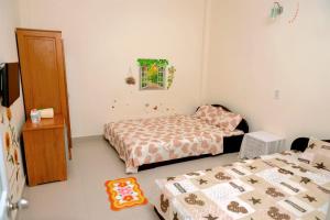 a small room with two beds and a window at Lucky Home in Nha Trang