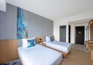 Cama o camas de una habitación en Oakwood Hotel & Apartments Taman Mini Jakarta