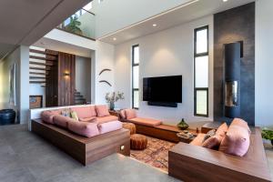 a living room with two couches and a flat screen tv at Stone & Wood I Private Properties in Yallingup