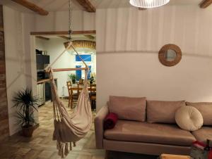 a living room with a couch and a hammock at Na początku in Budzów