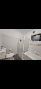 a bathroom with two sinks and a toilet and a shower at Hidden Gem North Sydney in Sydney +7 photos