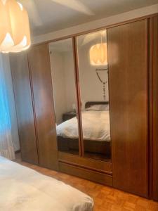 a bedroom with a closet with a bed in it at La Casa dei Nonni in Arta Terme