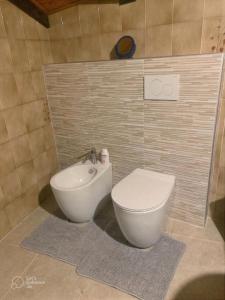 a bathroom with a toilet and a sink at La Casa dei Nonni in Arta Terme +22 photos