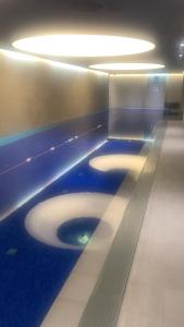 a bathroom with a toilet with blue walls and lights at Luxury apartment in London