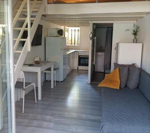 a small living room with a couch and a kitchen at Studio du Pouverel in La Garde