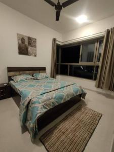 a bed in a bedroom with a window and a rug at Your Perfect Stay Awaits! in Thane