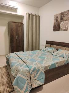 a bedroom with a bed with a quilt on it at Your Perfect Stay Awaits! in Thane
