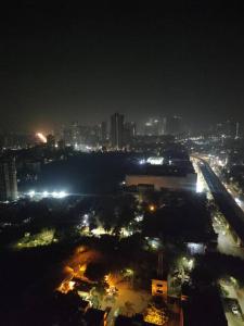 a view of a city at night with lights at Your Perfect Stay Awaits! in Thane