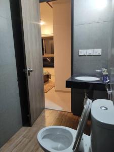 a bathroom with a toilet and a sink at Your Perfect Stay Awaits! in Thane