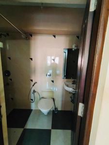 a bathroom with a toilet and a sink at 2BHK Affordable Apartment in North Goa - Baga and Anjuna Beach Nearby, Parra Road in Goa