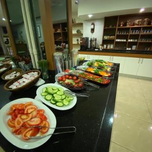 a buffet with plates of food on a counter at Hotel Villa Marina in Bandırma