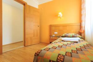 a bedroom with a bed with a colorful bedspread at Orka World Hotel & Aquapark in Oludeniz