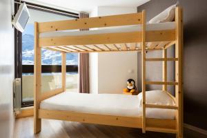 a bunk bed in a room with a window at SOWELL RESIDENCES Pierre Blanche in Les Menuires