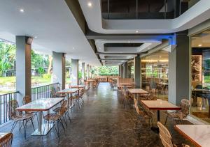 a row of tables and chairs in a restaurant at Oakwood Hotel & Apartments Taman Mini Jakarta in Jakarta