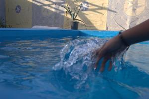 a person is in a pool of water at Abeer Guest House in Luxor