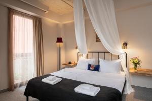 Postel nebo postele na pokoji v ubytování Galavani By Vintage Hotel Collections