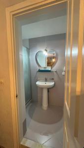 a bathroom with a sink and a mirror at Foca Antik Otel in Foca