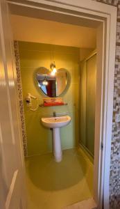 a bathroom with a sink and a mirror at Foca Antik Otel in Foca