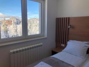 Postel nebo postele na pokoji v ubytování Apartman Srna 303 Jahorina