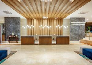 a lobby of a hotel with a reception desk at Oakwood Hotel & Apartments Taman Mini Jakarta in Jakarta