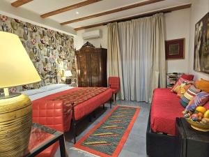 una camera con letto e divano di La Foresteria Garden Boutique B&B a Catania