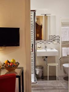 a bathroom with a sink and a bowl of fruit at La Foresteria Garden Boutique B&B in Catania