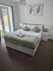 a bedroom with a large bed and a large window at Nariken Apartments in Bristol