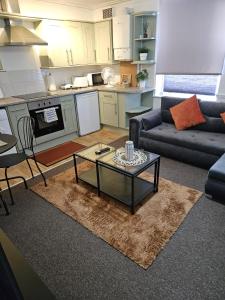 a living room with a couch and a table at Nariken Apartments in Bristol