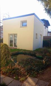 a house with a pond in front of it at Apartma Lilijana in Ljubljana