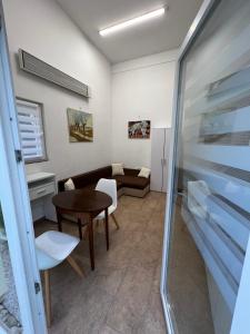 a living room with a table and a couch at Apartma Lilijana in Ljubljana