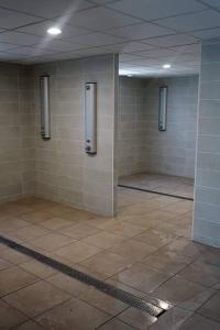 a bathroom with a tiled floor and walls with stalls at T2 rénové traversant double vue sur l 'étang in Le Barcarès