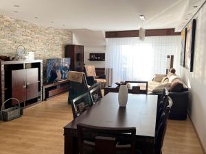 a living room with a table and a couch at Lux Apartmán Centrum in Topoľčany