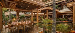 an outdoor restaurant with tables and chairs and a pool at Four Seasons Hotel in Limassol