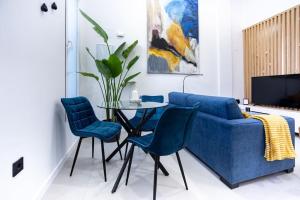 a living room with a blue couch and a table at Loft 11 B in Murcia